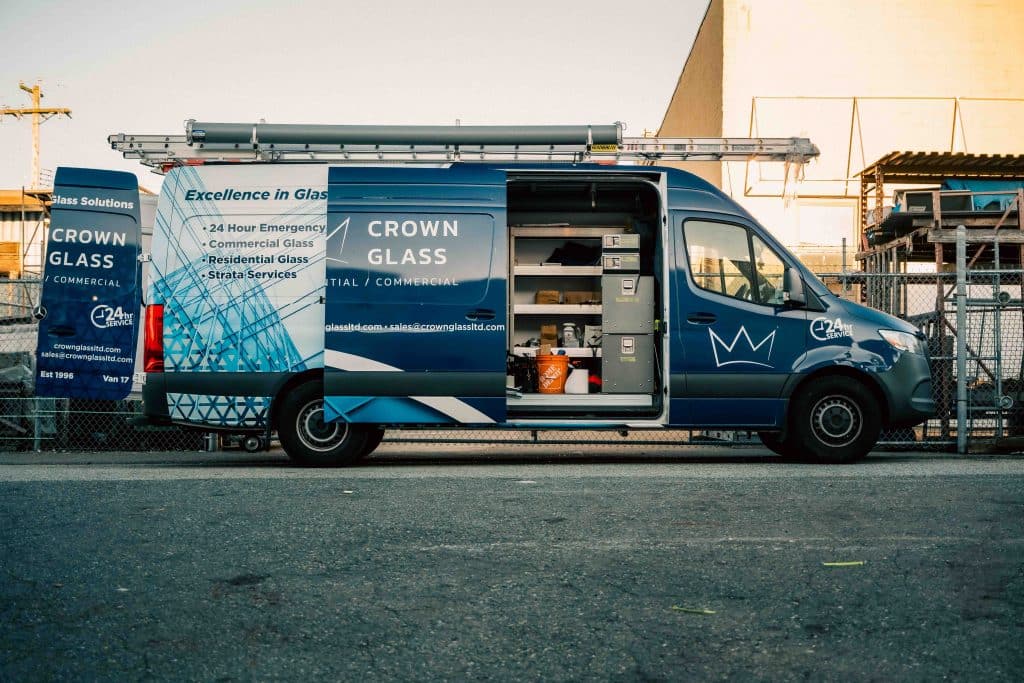 Side view of fully equipped Crown Auto Glass mobile service van ready for work